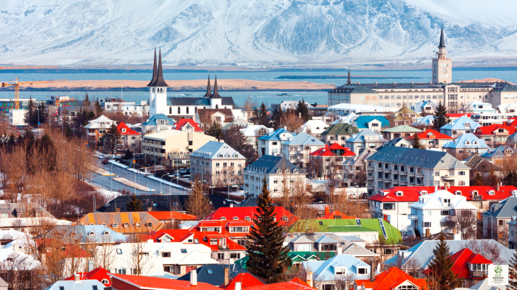 luxury in iceland with a Reykjavik cityscape featuring colorful rooftops, the harbor, and mountains in the distance