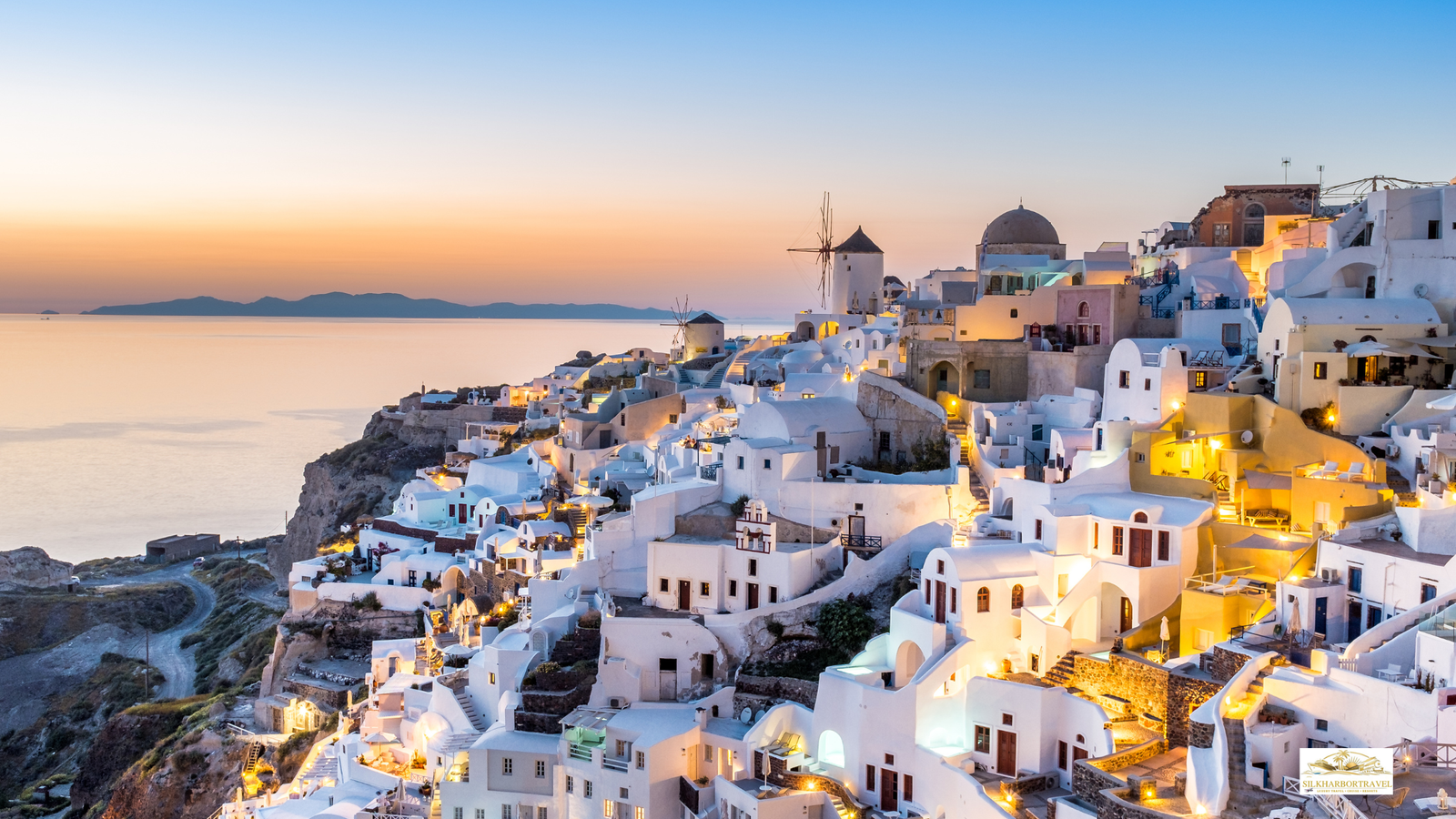 Luxury in Greece sunset in Oia, Santorini with whitewashed buildings and warm evening light