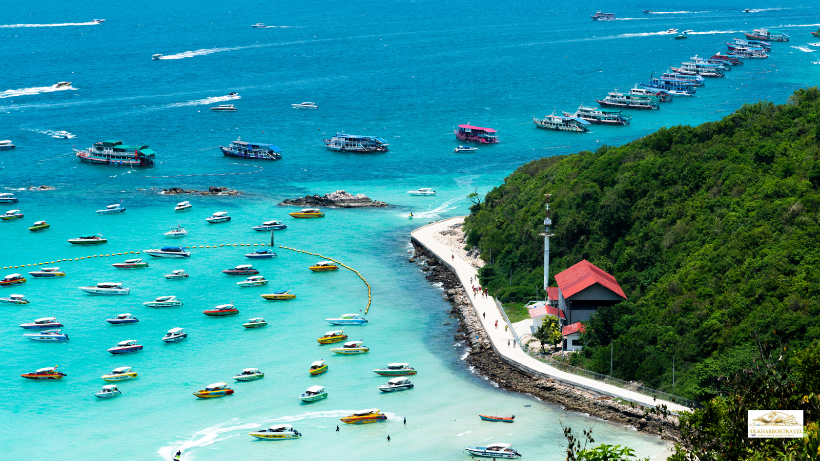 Luxury in Thailand aerial view of turquoise ocean coastline with large boats and yachts anchored near shore