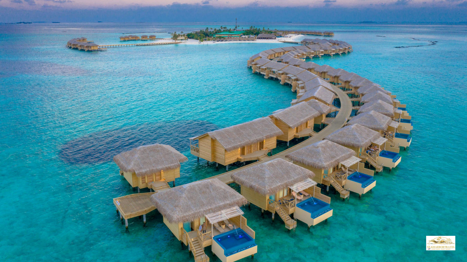 Luxury water villas in the Maldives over a turquoise lagoon, showcasing luxury travel with private decks and ocean views