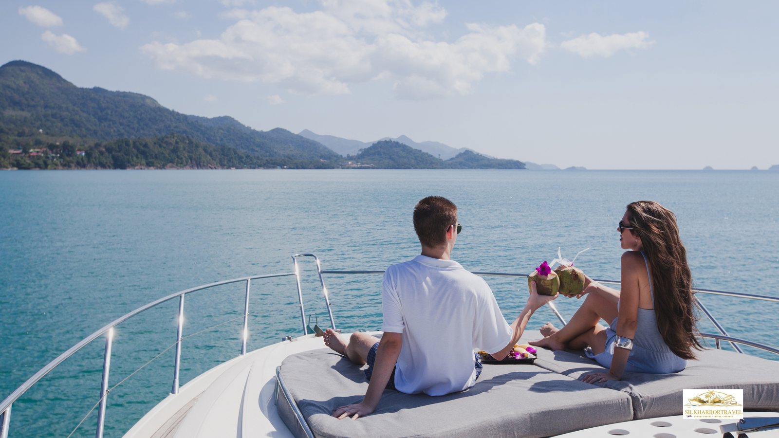 Younger couple enjoying drinks on a luxury boat deck with panoramic ocean views, capturing luxury travel