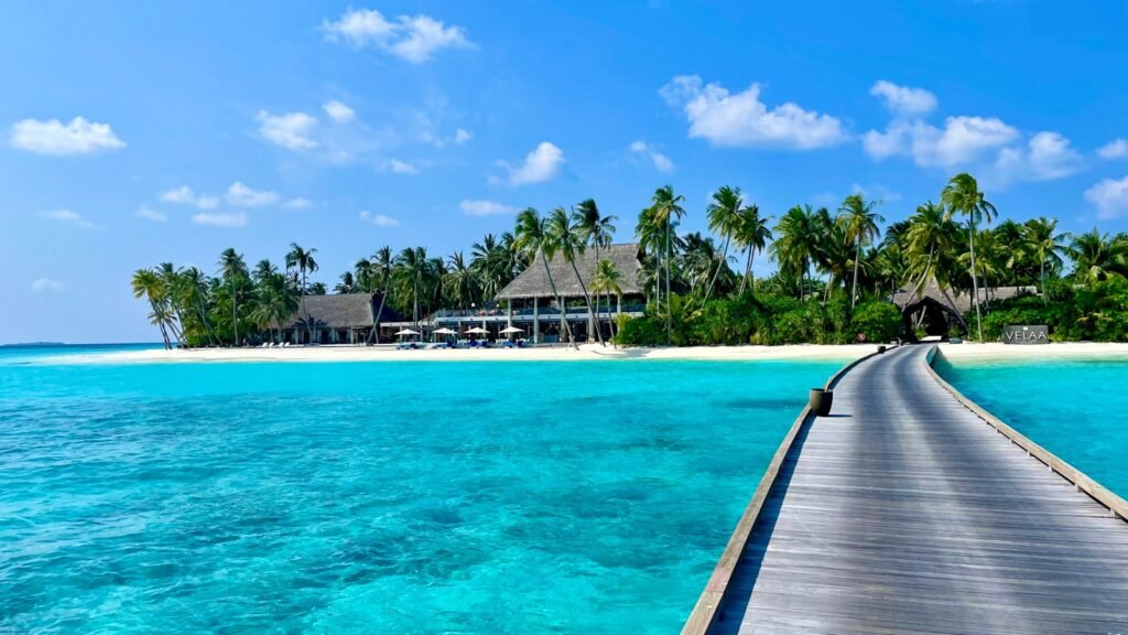 Overwater villa walkway stretching across turquoise lagoon in the Maldives—best overwater villas in the Maldives.