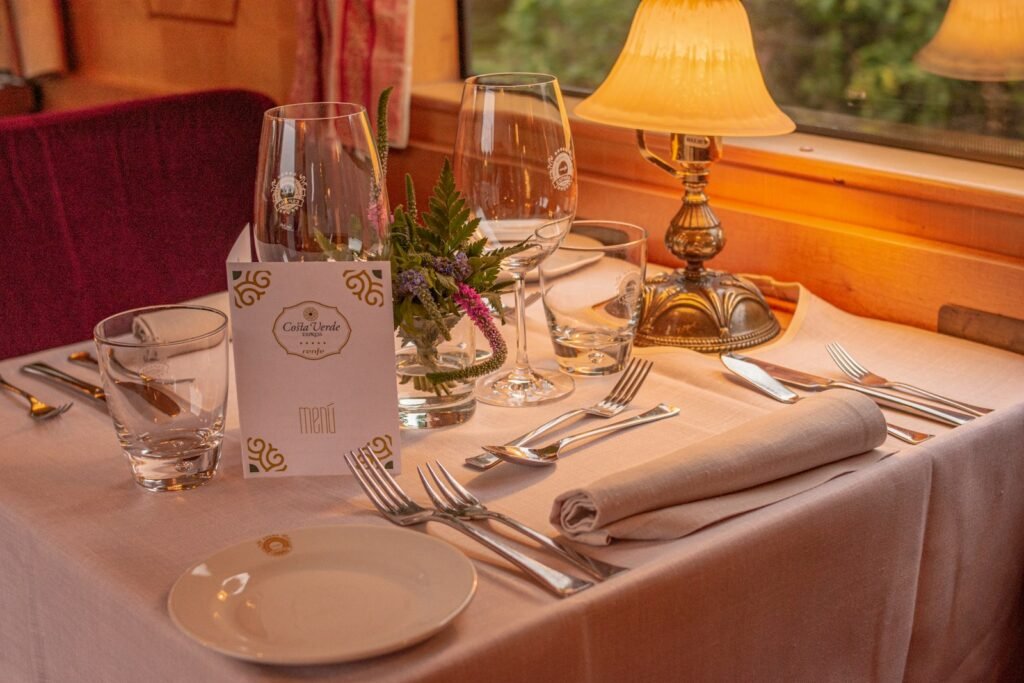 Formal dinner table set in a restaurant, matching the refined dining experience on luxury train trips