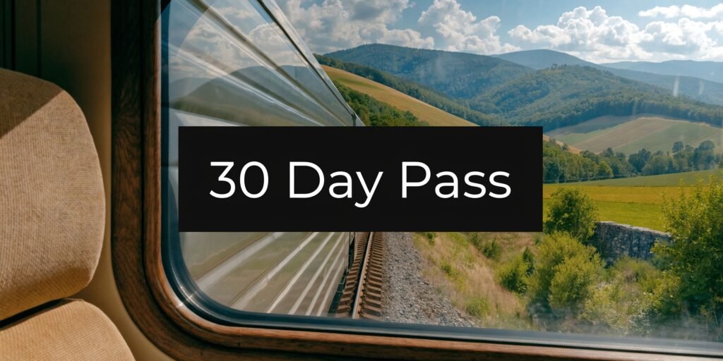 View from a train window across rolling hills, illustrating the amtrak 30 day pass for scenic long-distance rail travel