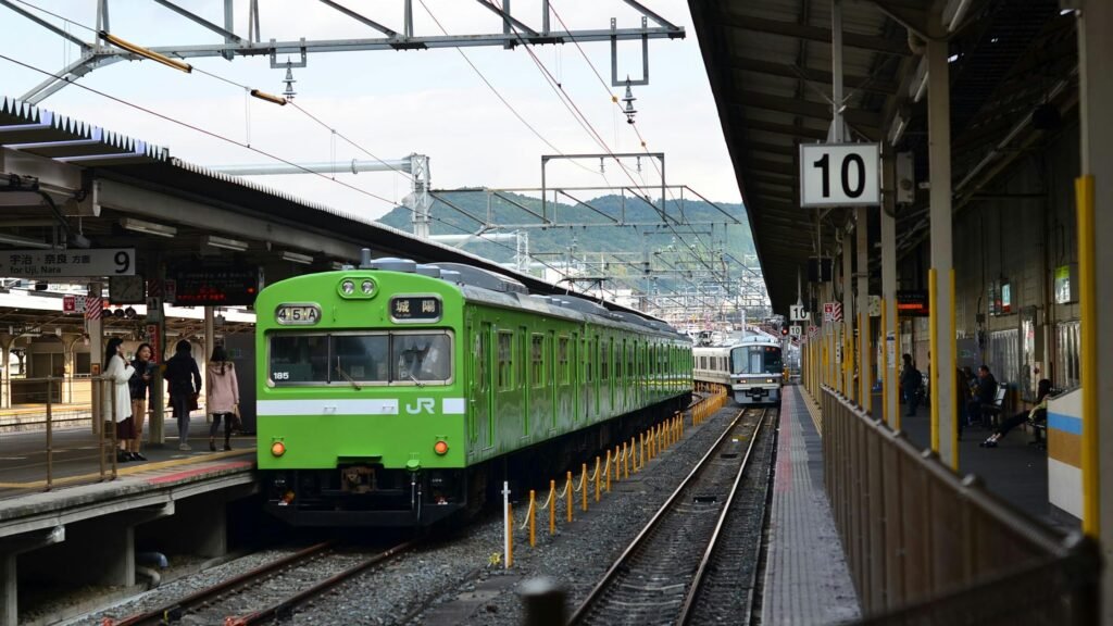 Green JR train at Kyoto Station for a luxury Japan itinerary by rail between Tokyo, Hakone, and Kyoto