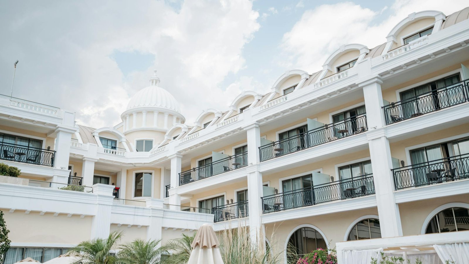 A classic resort facade under a bright sky, ideal as luxury travel imagery. Source: Pexels (Pavel Danilyuk).