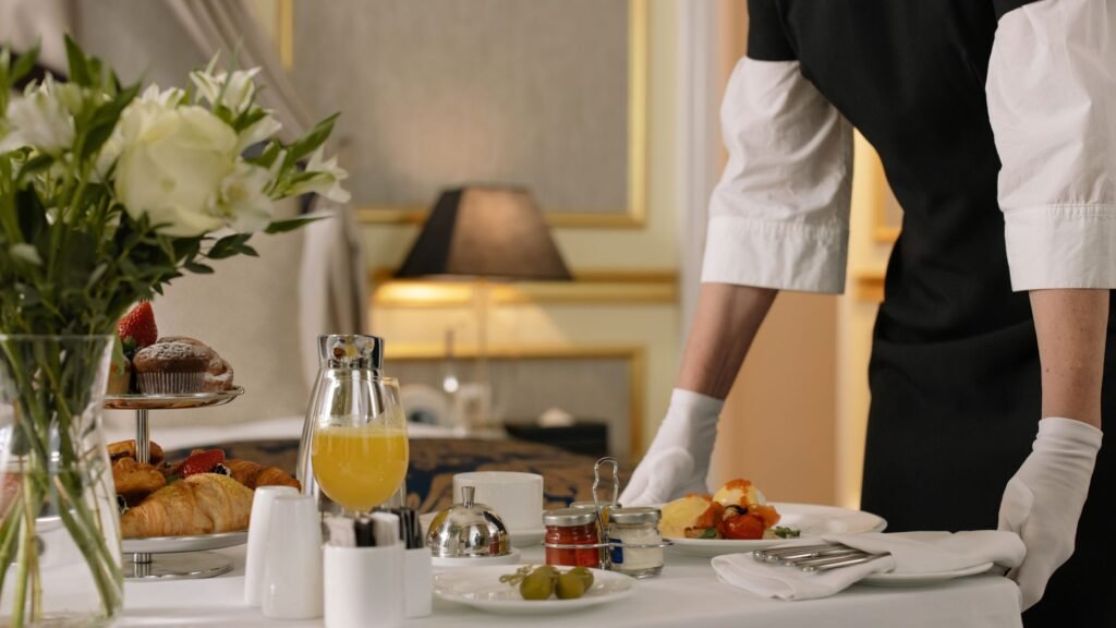 Featured image licensed via Pexels (photographer: cottonbro studio). Source: https://www.pexels.com/photo/person-serving-order-on-hotel-room-service-6466289/