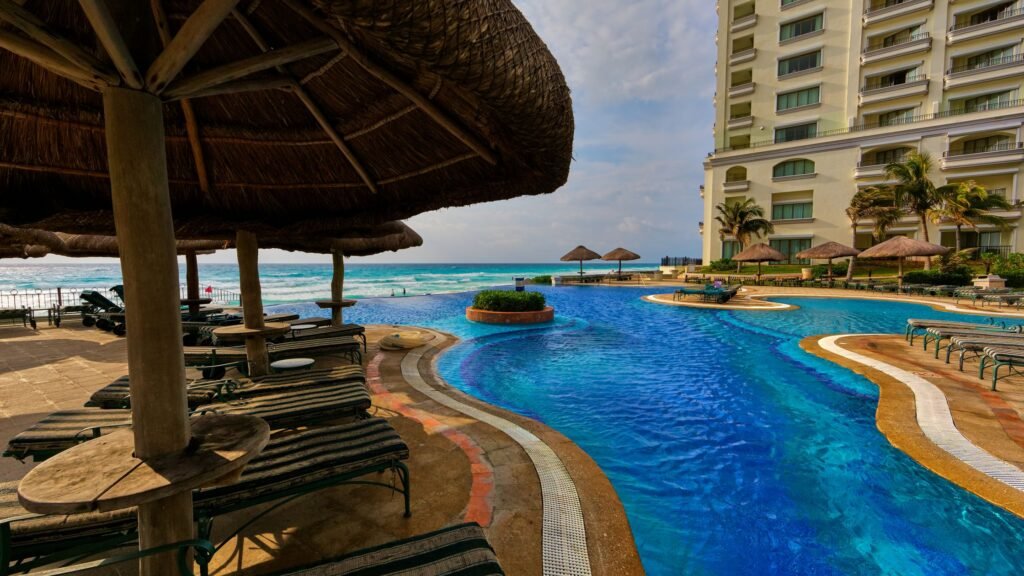 Featured image for luxury hotel loyalty perks showing a polished resort lounge and pool setting.