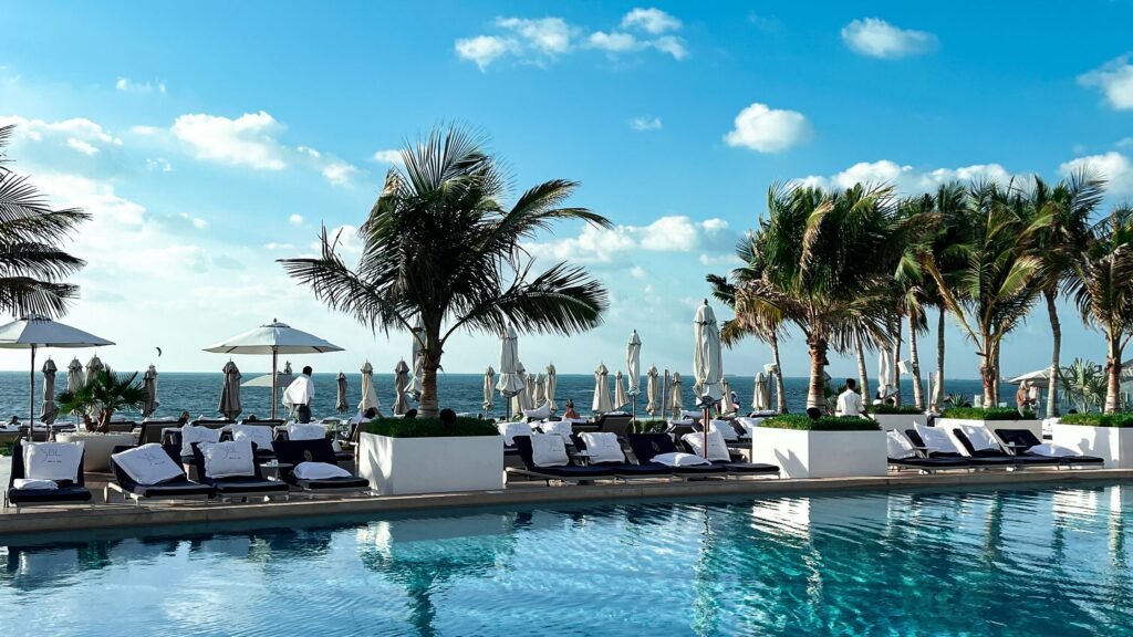Featured image for luxury spa resort guide showing a calm resort pool with loungers and palm trees.