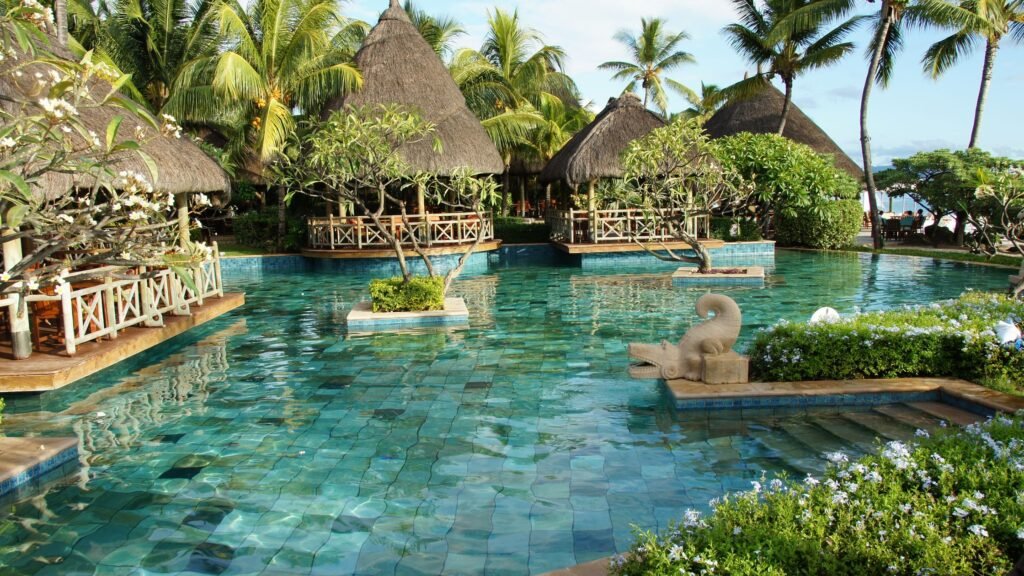Featured image for resort dining plan value showing a luxury beach restaurant beside a tropical resort pool.