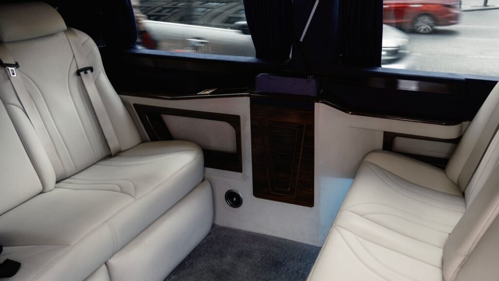 Featured image: luxury limousine interior with white leather seating. Photo by Yusuf Çelik via Pexels.