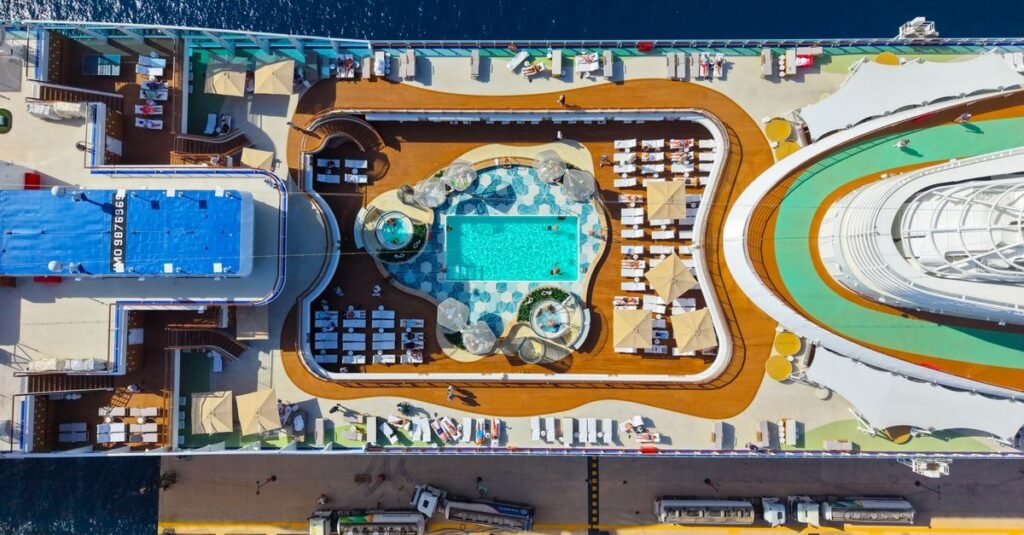 An upper deck pool area lined with loungers