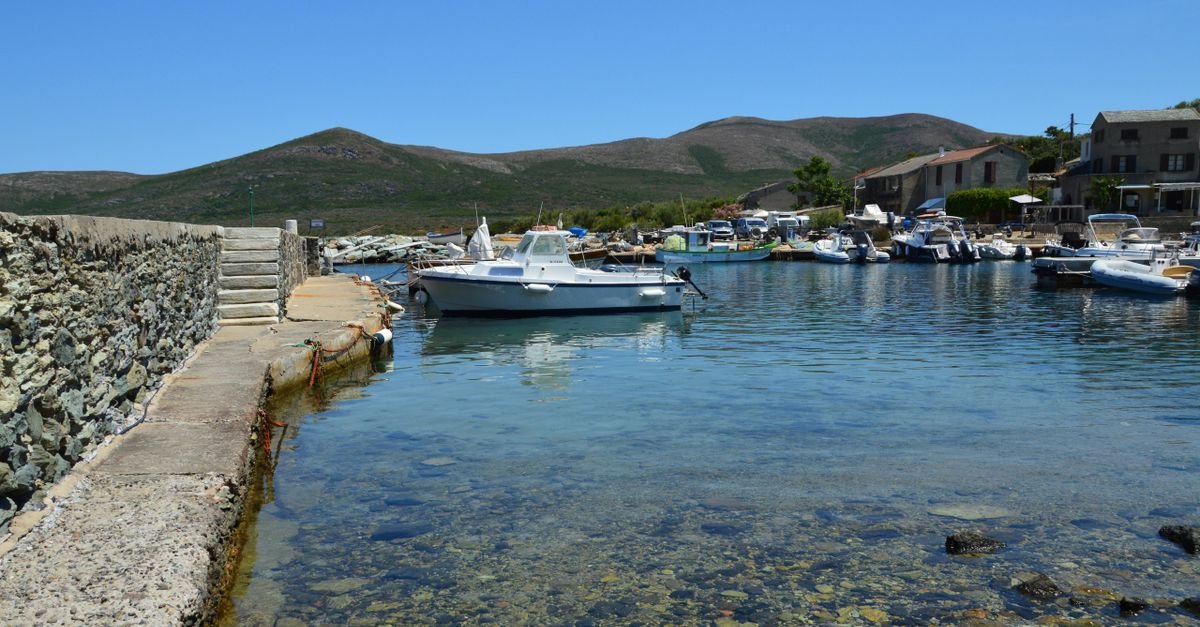 A small stone harbour with fishing boats