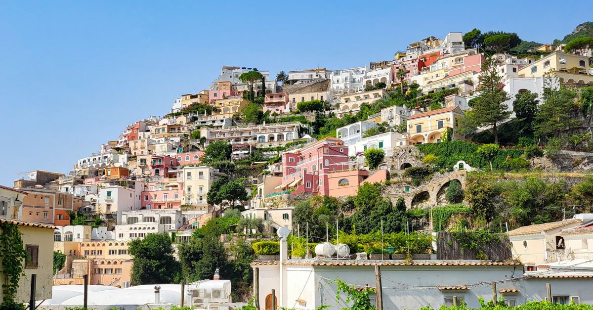 Pastel houses stacked on a steep Mediterranean hillside