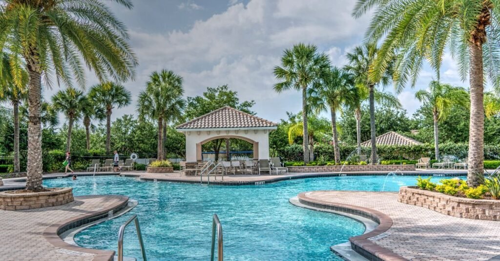 Hotel pool and palms with a city skyline behind