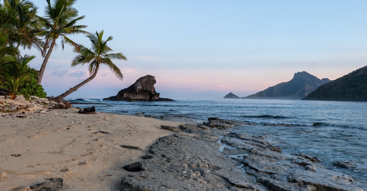 Palm-fringed white sand beach on a South Pacific island