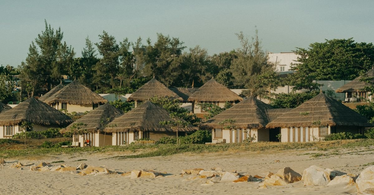 Thatched-roof bure bungalow among tropical planting