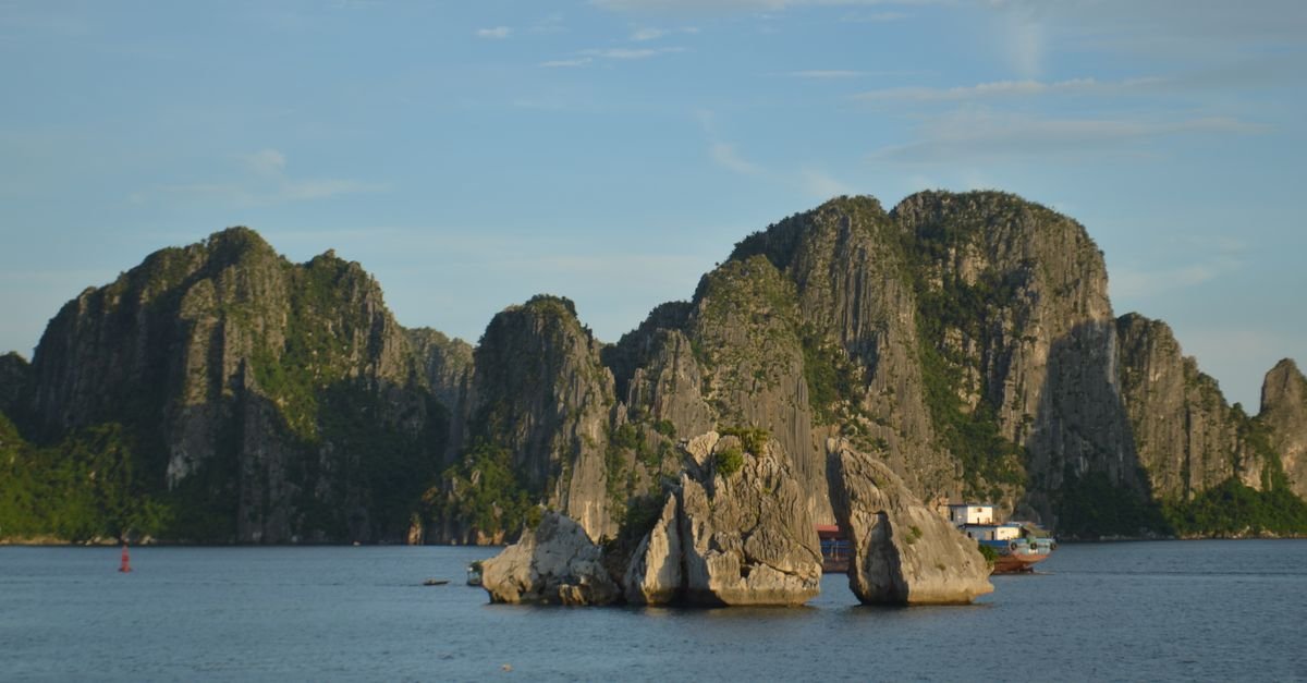 Limestone karsts rising from calm green water