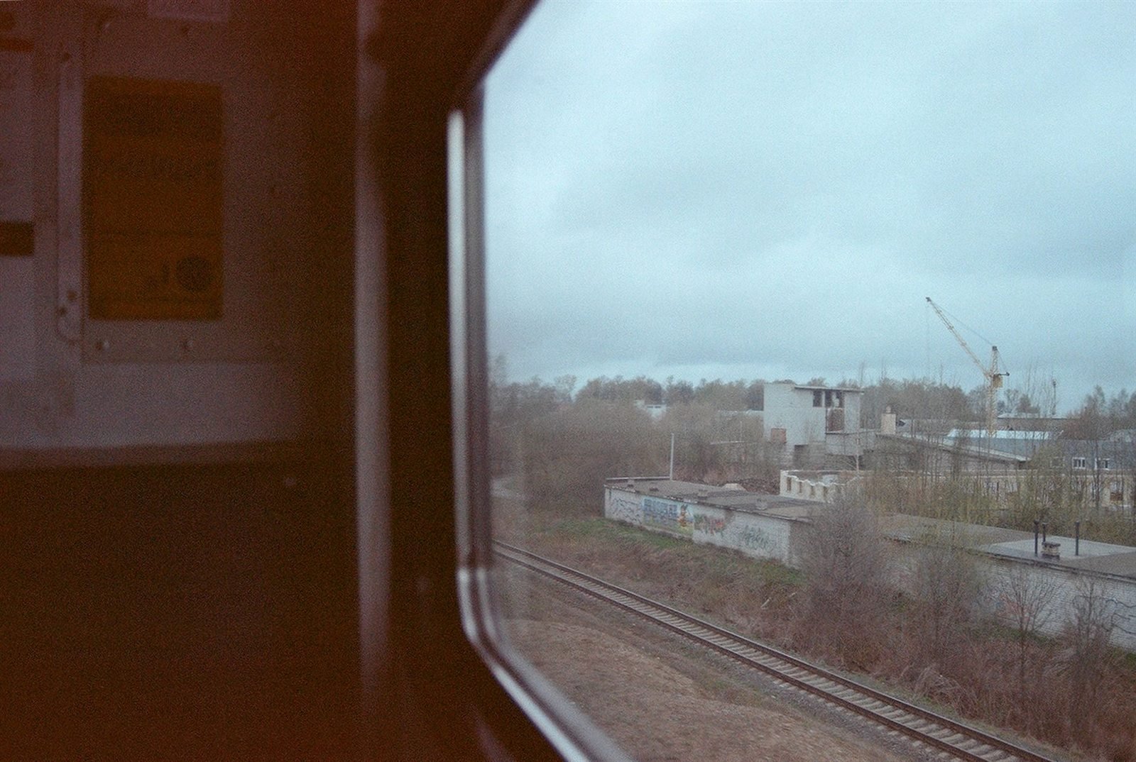 A view of passing countryside through the window of a moving train