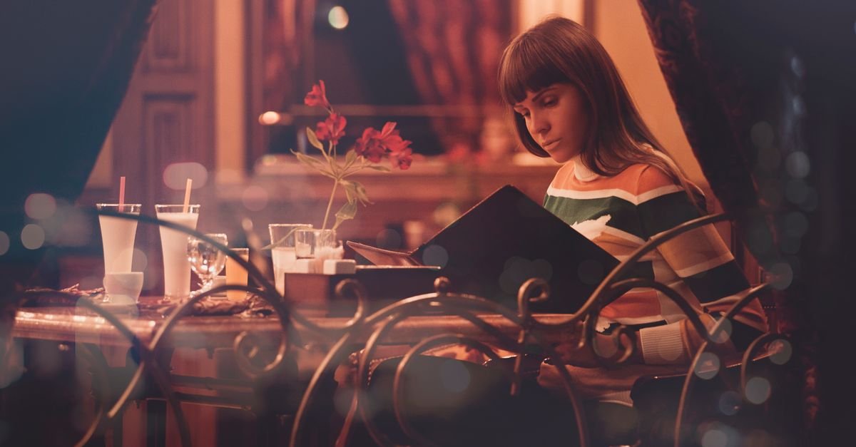 Someone eating alone at a restaurant window table