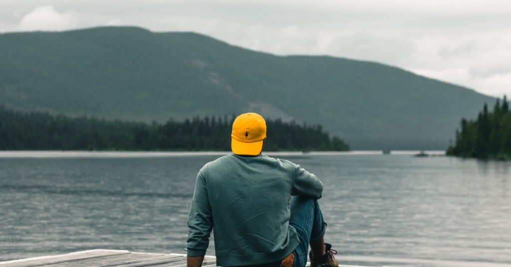 A solo traveller sitting and looking out at a view