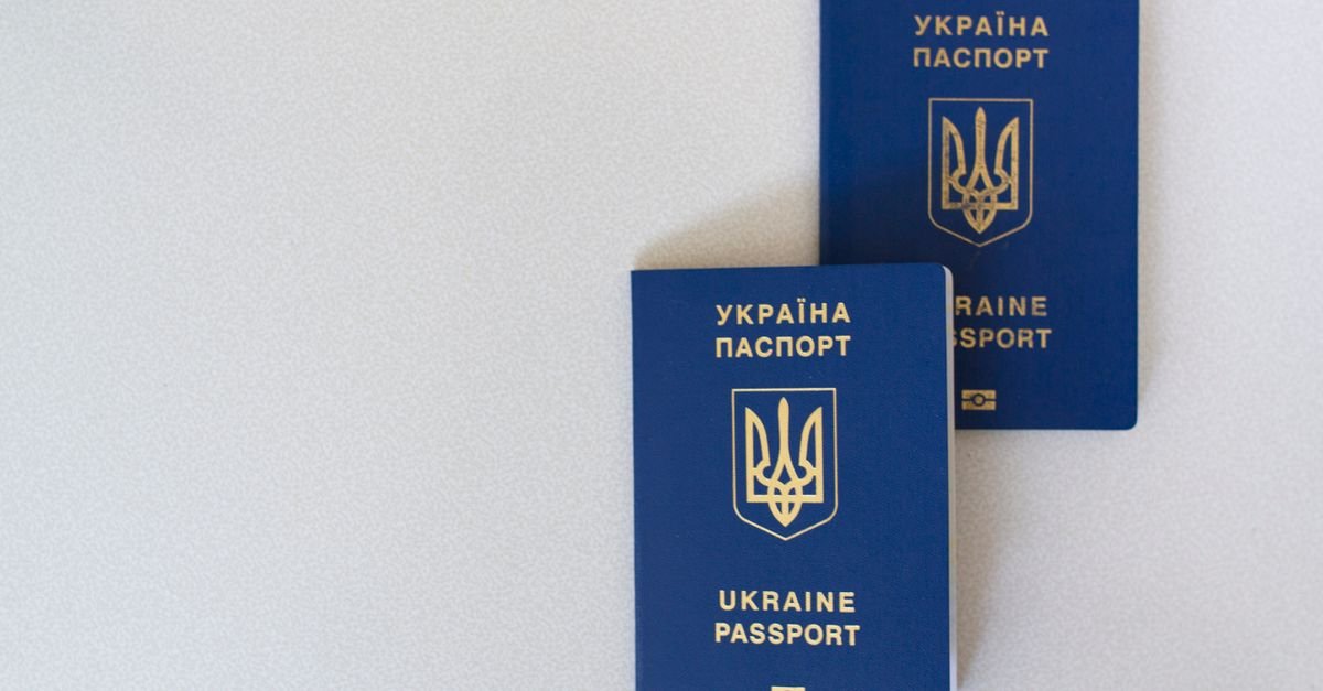 A passport and travel documents laid out on a desk